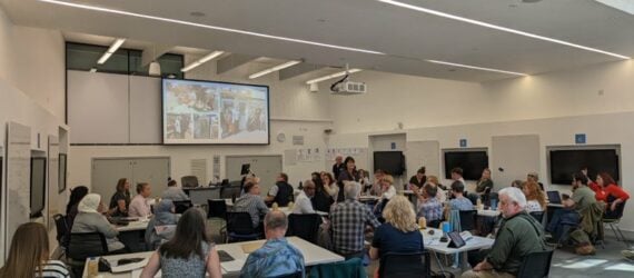 Room of people listening to a presentation