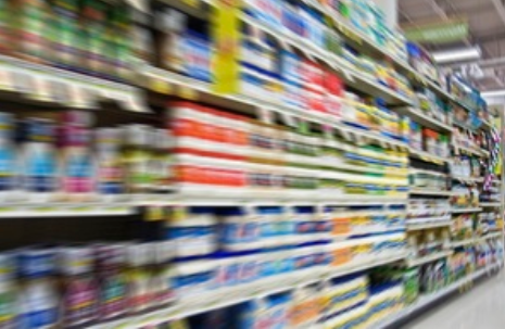 blurred image of full supermarket shelves