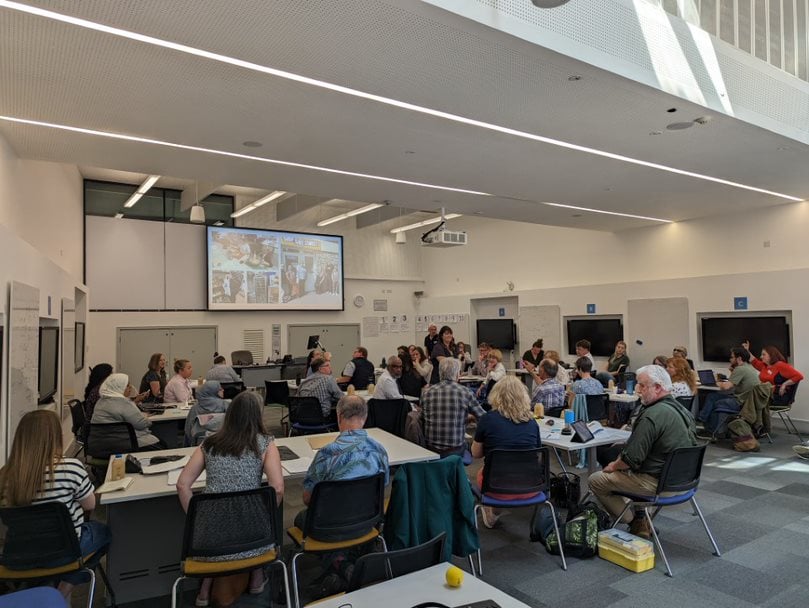 Room of people listening to a presentation