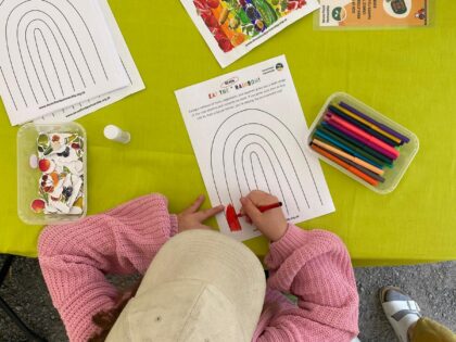 Child colouring in a rainbow