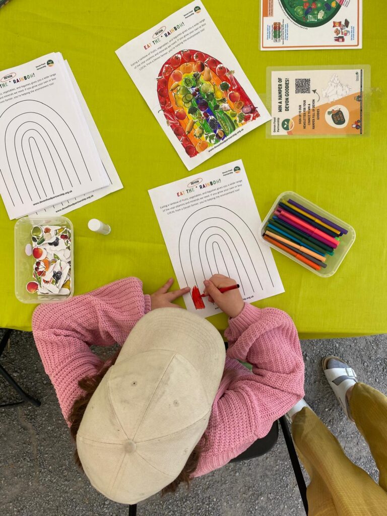 Child colouring in a rainbow