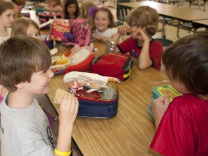 school children eating packed lunch