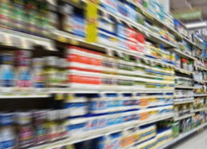 blurred image of full supermarket shelves