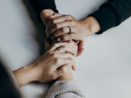 close up of hands holding one another for support