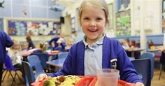 Child eating school meal canteen